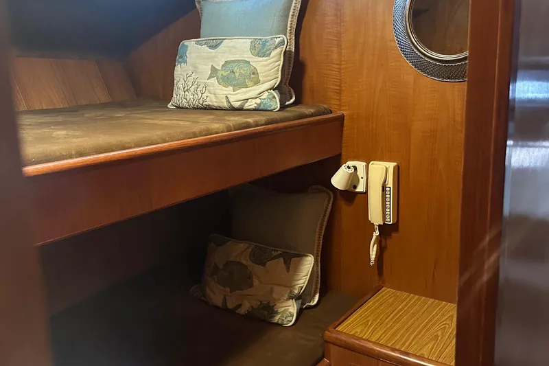 Slide: The Image of Cozy cabin interior of 1991 Symbol 39 sedan sportfisher with wooden bunk beds and nautical decor. - 26