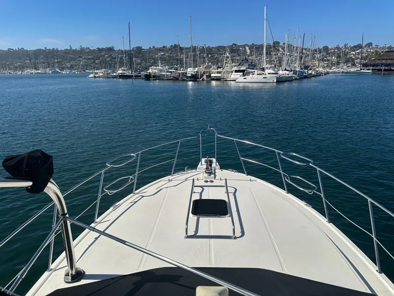 Slide: The Image of 1991 Symbol 39 Sedan Sportfisher yacht in marina, clear blue sky, calm water. - 7