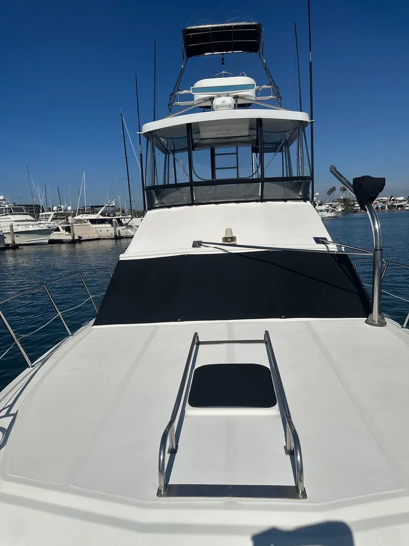 Slide: The Image of 1991 Symbol 39 Sedan Sportfisher docked at marina under clear blue sky. - 9