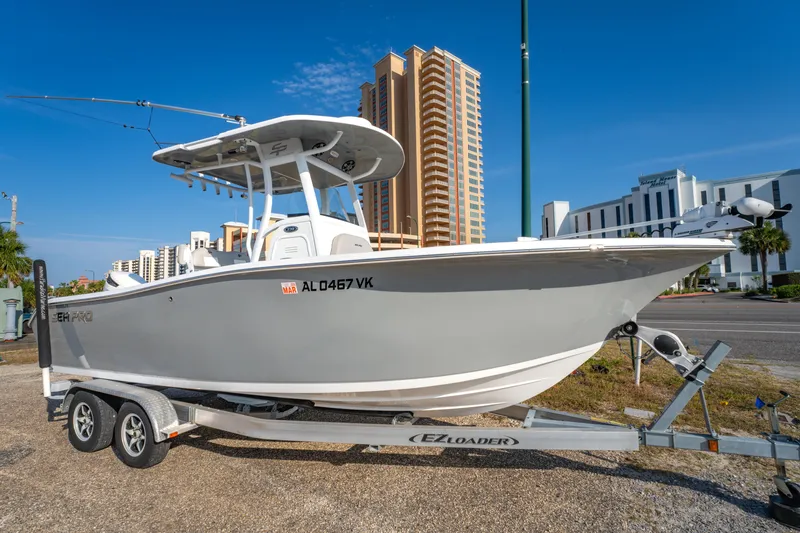 Slide: The Image of 2019 Sea Pro 239 DLX boat on trailer, urban background, clear sky. - 1