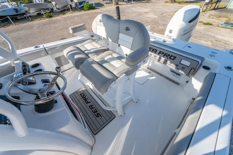 Slide: The Image of 2019 Sea Pro 239 DLX boat interior with dual seats and steering wheel. - 13