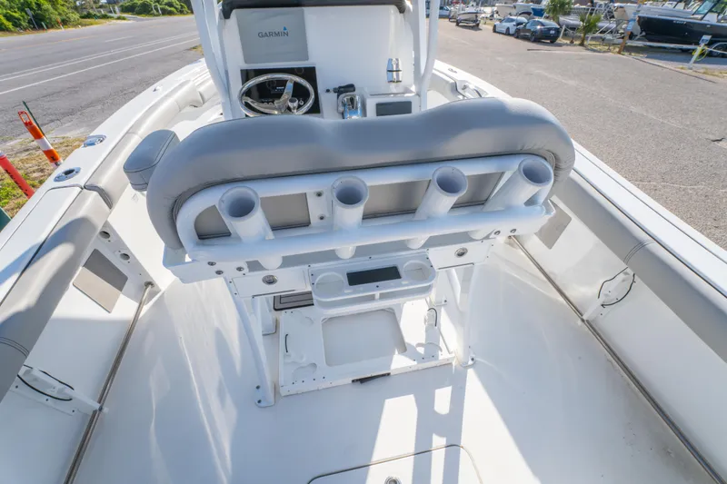 Slide: The Image of 2019 Sea Pro 239 DLX boat interior with rod holders and steering console. - 15