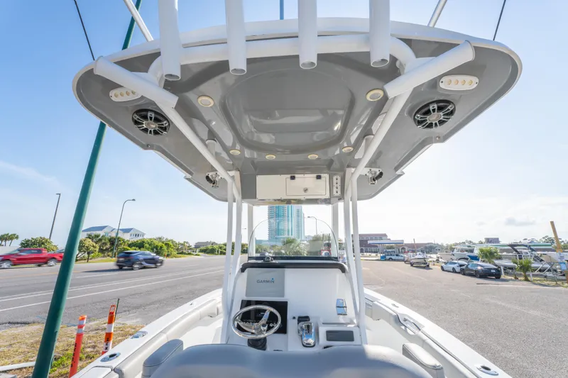 Slide: The Image of 2019 Sea Pro 239 DLX boat interior with modern helm and overhead speakers. - 17