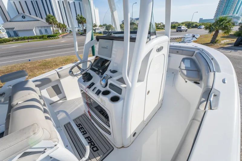Slide: The Image of 2019 Sea Pro 239 DLX boat interior with modern console and seating. - 18