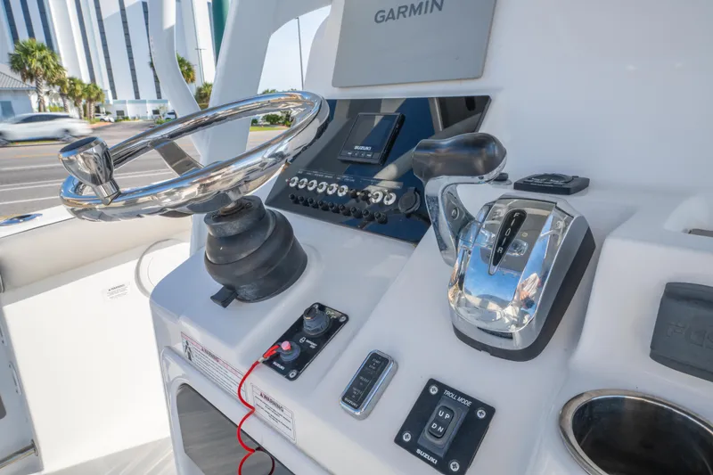 Slide: The Image of 2019 Sea Pro 239 DLX boat console with Garmin navigation and controls. - 19