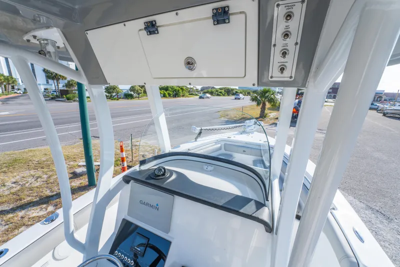 Slide: The Image of 2019 Sea Pro 239 DLX boat console with Garmin navigation system and overhead storage. - 21