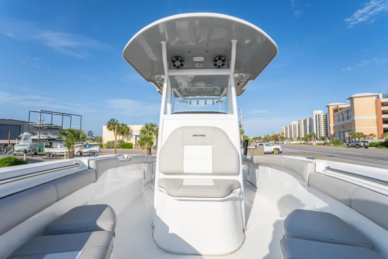 Slide: The Image of 2019 Sea Pro 239 DLX boat with spacious seating and modern design, docked under a clear blue sky. - 24