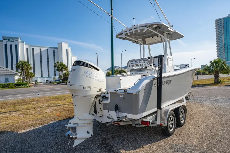 Slide: The Image of 2019 Sea Pro 239 DLX boat on trailer, parked near modern buildings. - 3