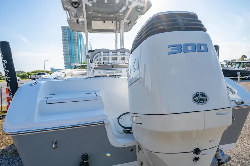 Slide: The Image of 2019 Sea Pro 239 DLX boat with 300 horsepower engine, docked under clear sky. - 4