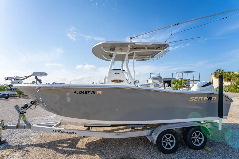 Slide: The Image of 2019 Sea Pro 239 DLX boat on trailer under clear blue sky. - 6