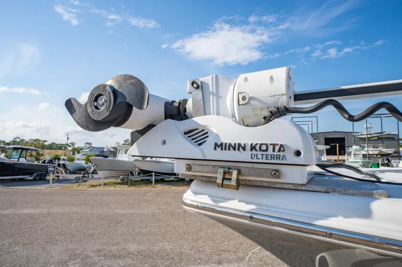 Slide: The Image of Minn Kota Ulterra motor on 2019 Sea Pro 239 DLX boat, sunny day, marina background. - 8