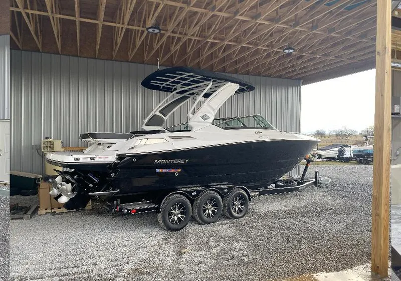 Slide: The Image of 2023 Monterey 298 Super Sport boat on trailer in covered storage area. - 3