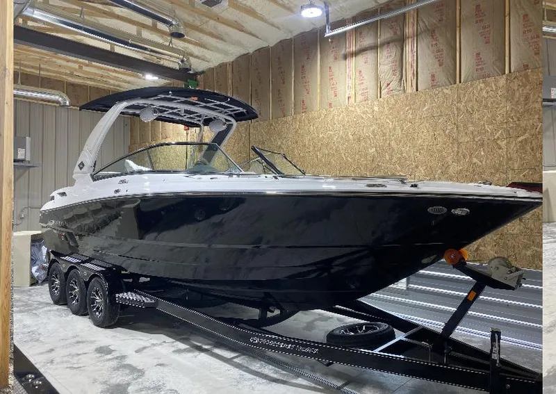 Slide: The Image of 2023 Monterey 298 Super Sport boat in a garage on a trailer. - 4