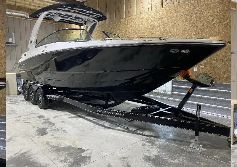 Slide: The Image of 2023 Monterey 298 Super Sport boat on trailer in a garage setting. - 5