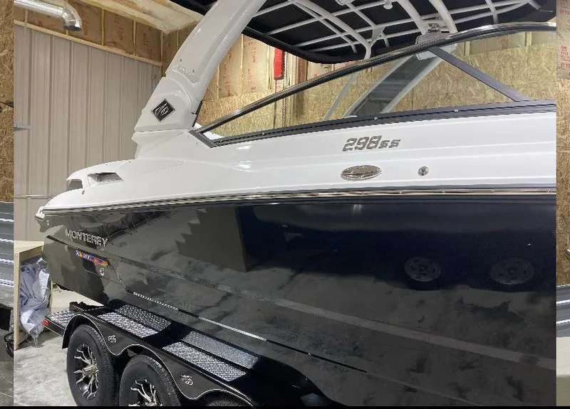 Slide: The Image of 2023 Monterey 298 Super Sport boat in a garage, showcasing sleek design and modern features. - 6