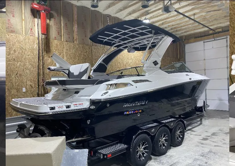 Slide: The Image of 2023 Monterey 298 Super Sport boat in a garage on a trailer. - 7