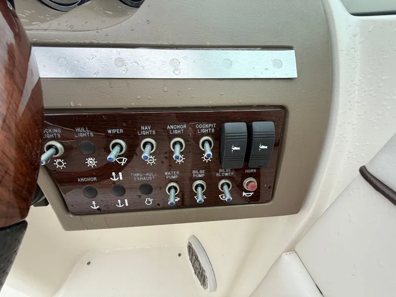 Slide: The Image of Control panel of a 2012 Sea Ray 280 Sundeck boat with various switches and buttons. - 12