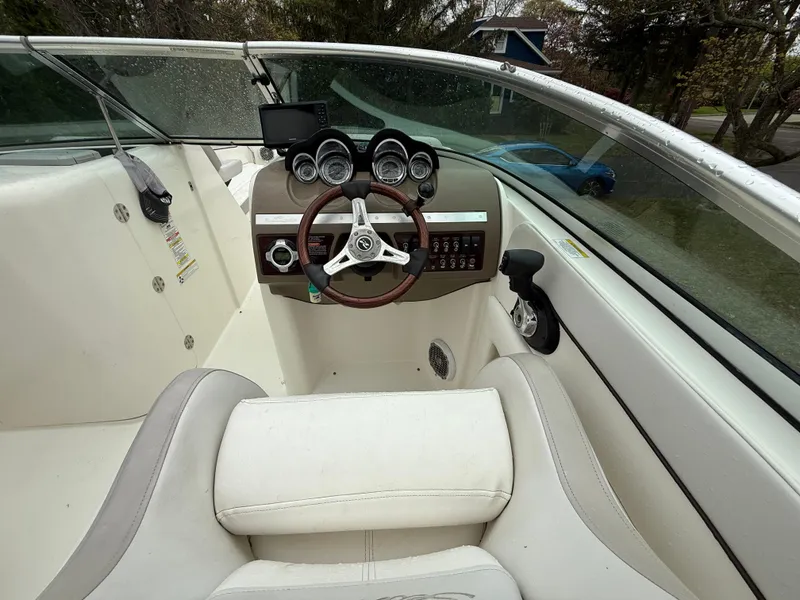 Slide: The Image of 2012 Sea Ray 280 Sundeck boat interior with steering wheel and dashboard controls. - 13