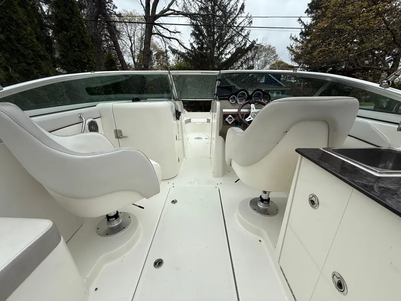Slide: The Image of 2012 Sea Ray 280 Sundeck interior with white seating and dashboard view. - 14