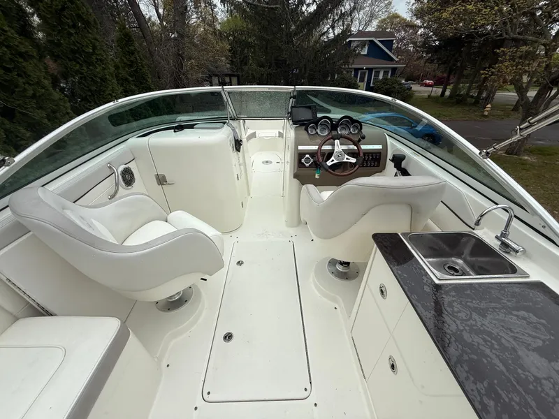 Slide: The Image of 2012 Sea Ray 280 Sundeck interior with helm, seating, and sink. - 15