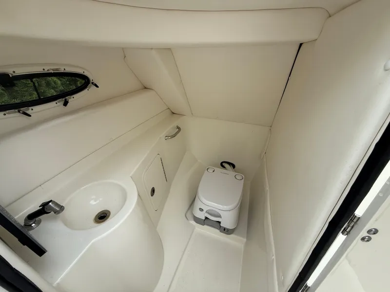 Slide: The Image of Interior of 2012 Sea Ray 280 Sundeck boat bathroom with sink and portable toilet. - 16