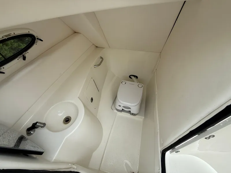 Slide: The Image of 2012 Sea Ray 280 Sundeck boat bathroom with sink and portable toilet. - 18