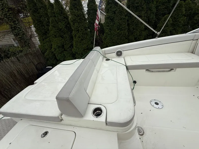 Slide: The Image of 2012 Sea Ray 280 Sundeck boat with white seating and American flag. - 23