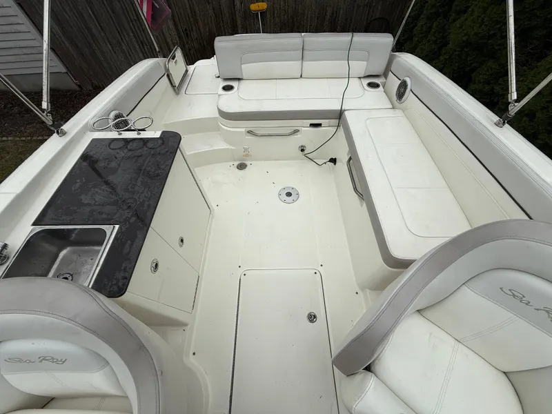 Slide: The Image of 2012 Sea Ray 280 Sundeck interior with seating and kitchenette. - 25