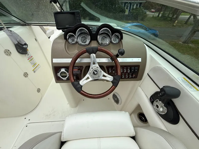 Slide: The Image of 2012 Sea Ray 280 Sundeck dashboard with steering wheel and instrument panel. - 9
