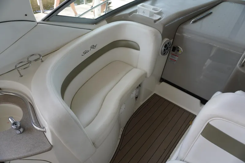 Slide: The Image of 2006 Sea Ray 320 Sundancer interior with white seating and wood flooring. - 10