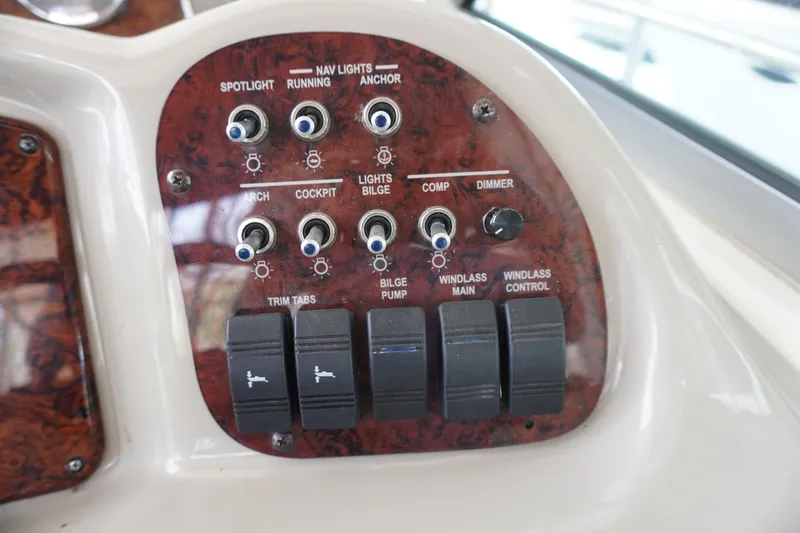 Slide: The Image of Control panel of a 2006 Sea Ray 320 Sundancer boat with various switches and dials. - 14