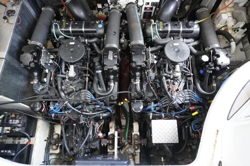 Slide: The Image of Engine room of a 2006 Sea Ray 320 Sundancer with dual engines and complex wiring. - 15