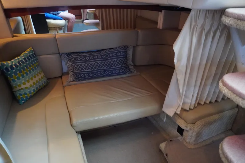 Slide: The Image of Interior of 2006 Sea Ray 320 Sundancer with beige seating and decorative pillows. - 17