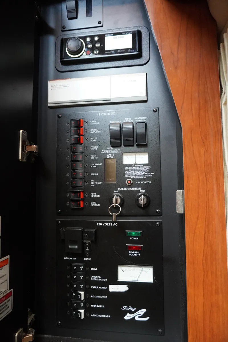 Slide: The Image of Control panel of a 2006 Sea Ray 320 Sundancer boat, featuring switches and gauges. - 18