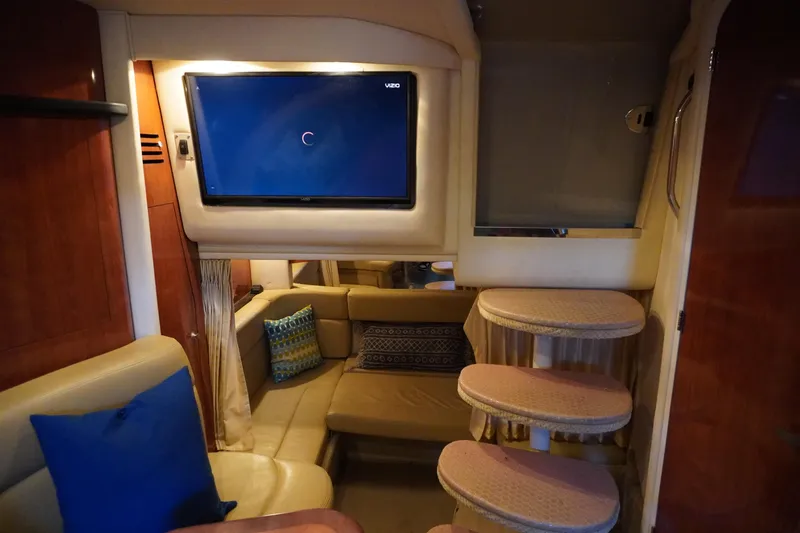 Slide: The Image of Interior of 2006 Sea Ray 320 Sundancer with cozy seating and mounted TV. - 21