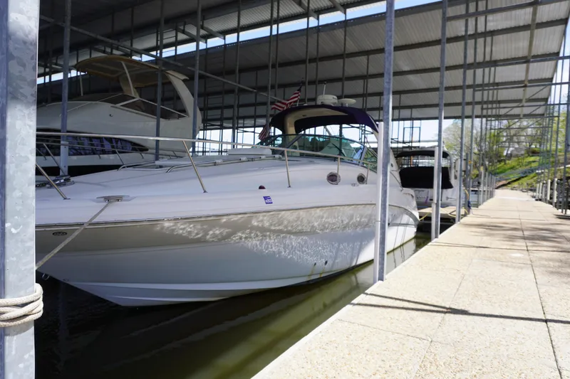 Slide: The Image of 2006 Sea Ray 320 Sundancer docked in a covered marina. - 3