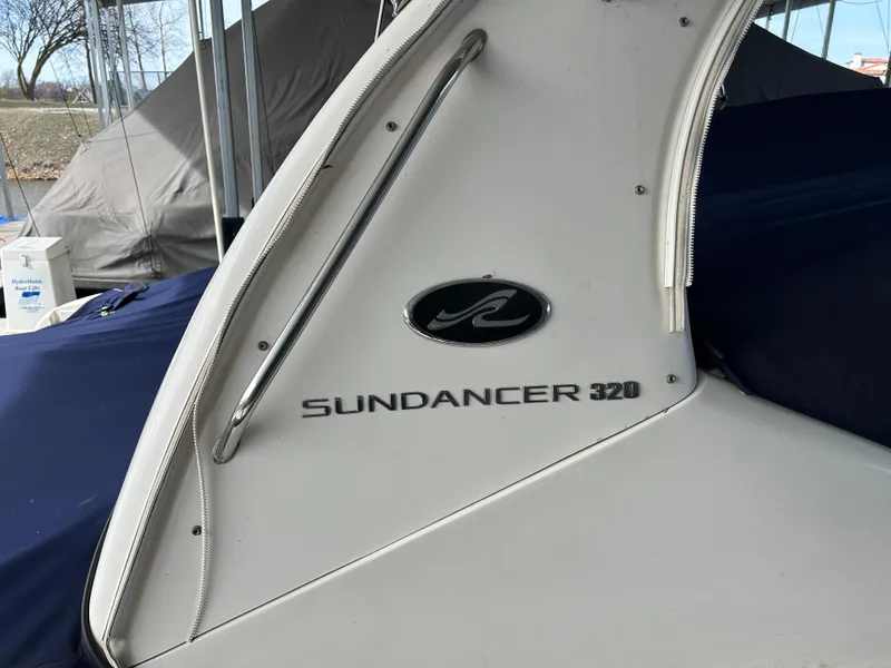 Slide: The Image of 2006 Sea Ray 320 Sundancer boat, side view with logo and model name. - 4