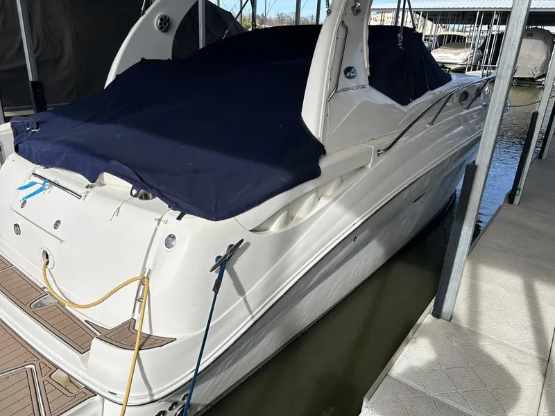 Slide: The Image of 2006 Sea Ray 320 Sundancer docked, covered with a navy blue tarp. - 6