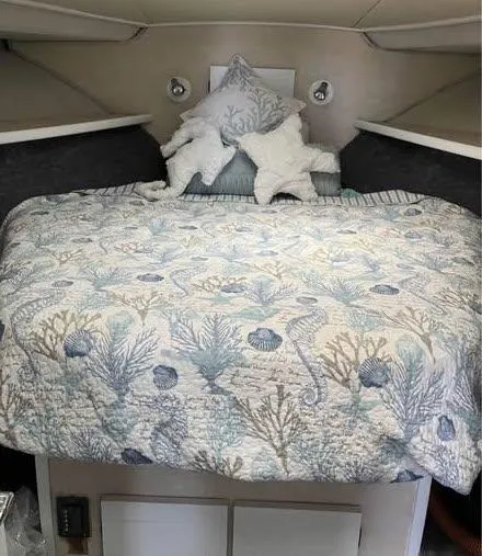 Slide: The Image of Cozy bedroom in 1990 Silverton 40 Convertible boat with nautical-themed bedding. - 10