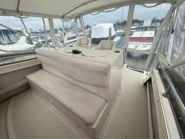 Slide: The Image of 1990 Silverton 40 Convertible boat interior with helm and seating area. - 13
