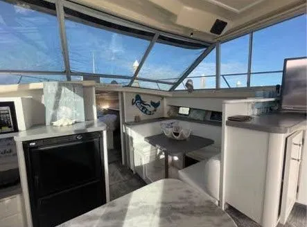 Slide: The Image of Interior of a 1990 Silverton 40 Convertible yacht with modern furnishings. - 7