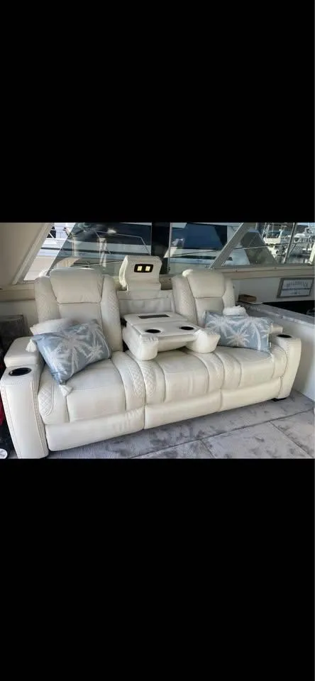 Slide: The Image of Luxurious seating on a 1990 Silverton 40 Convertible yacht with plush cushions and cup holders. - 8