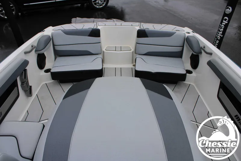 Slide: The Image of 2024 Malibu TXi Mo boat interior with gray seating and Chessie Marine logo. - 10