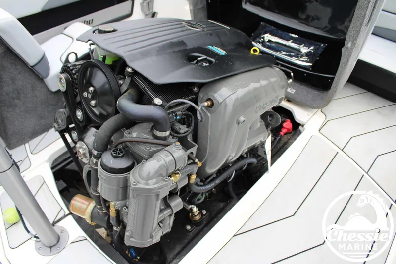 Slide: The Image of 2024 Malibu TXi Mo boat engine, detailed view in open compartment. - 12