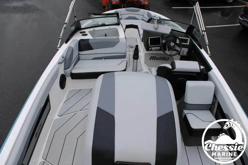 Slide: The Image of 2024 Malibu TXi Mo boat interior with sleek seating and modern dashboard design. - 15