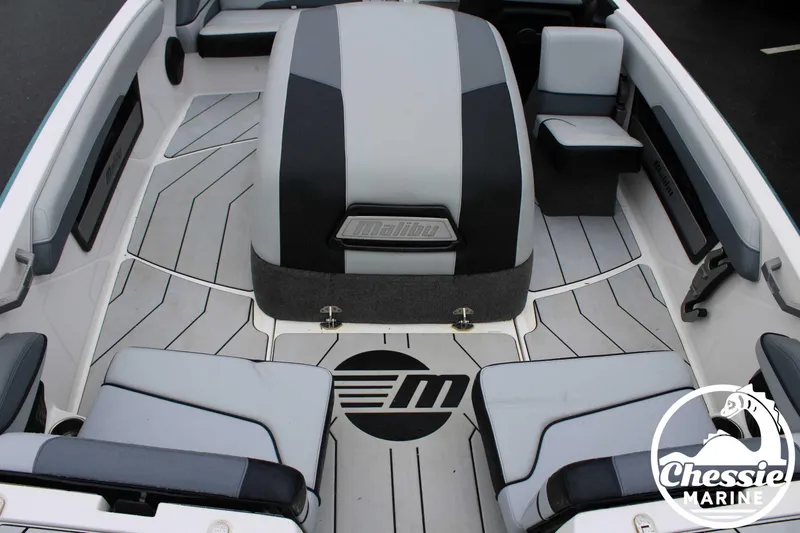 Slide: The Image of 2024 Malibu TXi Mo boat interior with sleek seating and modern design. - 17