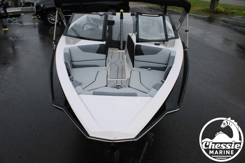 Slide: The Image of 2024 Malibu TXi Mo boat with sleek design and spacious seating, displayed at Chessie Marine. - 18