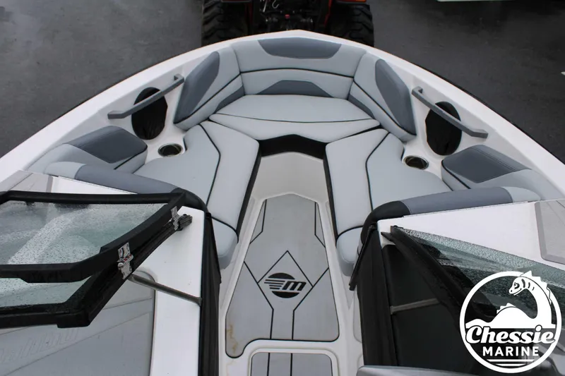 Slide: The Image of 2024 Malibu TXi Mo boat interior with gray seating and Chessie Marine logo. - 22
