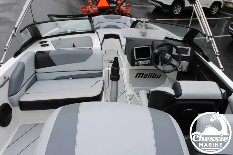 Slide: The Image of 2024 Malibu TXi Mo boat interior with sleek seating and modern dashboard design. - 23