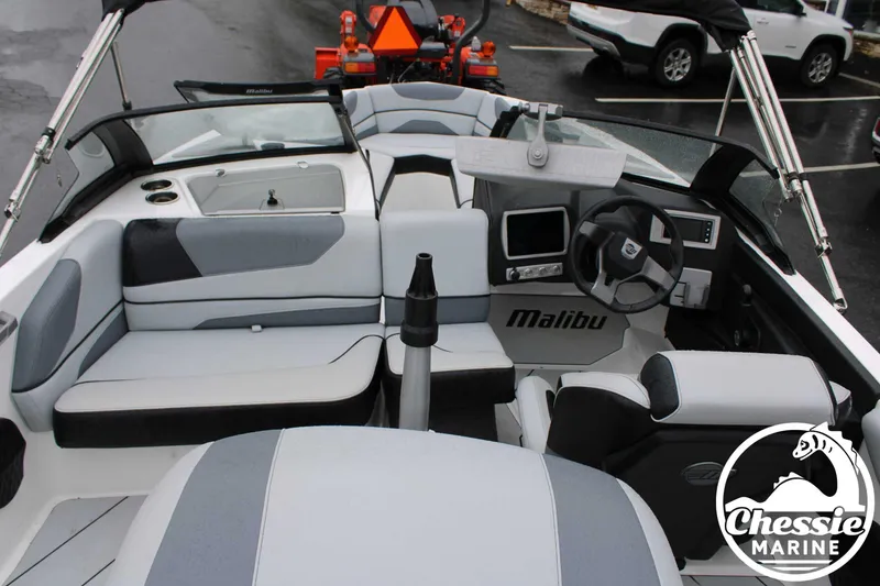 Slide: The Image of 2024 Malibu TXi Mo boat interior with modern dashboard and seating, displayed at Chessie Marine. - 25
